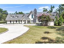 Stunning single Gathering home with a circular driveway, beautiful landscaping, and a stone chimney at 3114 Little Rd, Valrico, FL 33596