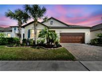 Charming single-Gathering home with a two-car garage, manicured landscaping, and a brick driveway at 31637 Cannon Rush Dr, San Antonio, FL 33576