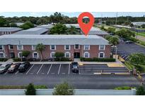 Brick two-story condo building with well-maintained landscaping and assigned parking spaces in a desirable neighborhood at 3815 35Th S Way # 102, St Petersburg, FL 33711