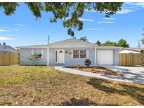 Charming single-story home with a well-maintained front yard, walkway, and attached garage at 4220 Oakfield Ave, Holiday, FL 34691