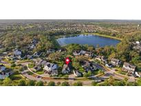 Beautiful aerial view of lakeside community with well-maintained lawns and mature trees at 5903 Nature Ridge Ln, Lithia, FL 33547