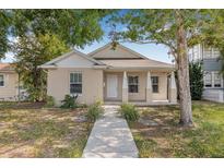Charming home with stucco exterior, inviting front porch, and landscaped walkway at 718 30Th N Ave, St Petersburg, FL 33704