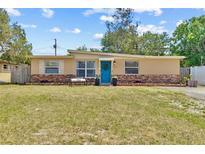Charming single-story home with a well-maintained lawn, blue front door, and decorative brick accents at 8184 Rose Ter, Seminole, FL 33777