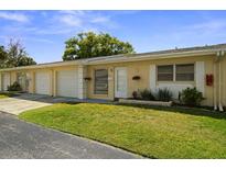 Charming single-story home with a well-maintained lawn and attached one car garage at 834 Cambridge Ct, Dunedin, FL 34698