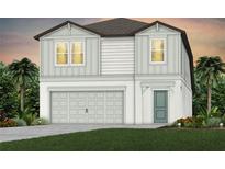 Charming two-story home featuring a two-car garage, neutral color palette, and lush landscaping at 9768 Crescent Moon Dr, Riverview, FL 33578