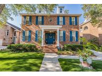 Charming brick home featuring blue shutters and a manicured lawn for inviting curb appeal at 2704 Chambray Ln, Tampa, FL 33611