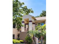 Inviting two-story townhome with covered entry, well-maintained landscaping, and a welcoming facade at 7828 Hardwick # 923, New Port Richey, FL 34655