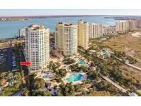 An aerial view of the condominiums and pool area with views of the bay and ocean at 1170 Gulf Blvd # 402, Clearwater, FL 33767