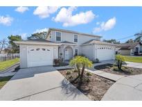 Charming two-story home with attached two-car garage and well-maintained landscaping on a sunny day at 11780 Linden Dr, Spring Hill, FL 34608