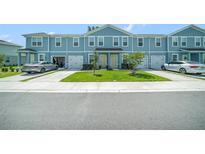 Charming two-story townhome with a well-manicured lawn and driveway at 12264 Grizzly Ln, New Port Richey, FL 34654
