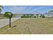 Charming single-story home with a well-maintained front yard and attached garage at 1809 Haverford Ave, Sun City Center, FL 33573