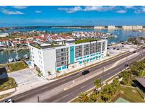 An aerial view of the Residences showcasing its premium bayside location, rooftop deck, and water views at 400 150Th Ave # 506, Madeira Beach, FL 33708