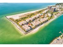 Stunning aerial view of beachfront condos with private beach access and turquoise waters at 7480 Bayshore Dr # 402, Treasure Island, FL 33706