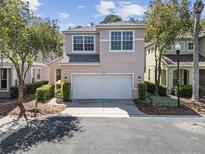 Two-story home featuring an attached two-car garage, manicured landscaping, and neutral stucco exterior at 10503 Dotham Ct, Tampa, FL 33626