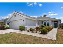 Well-maintained single Gathering home with manicured landscaping and a two-car garage at 1112 Jasmine Creek Ct, Sun City Center, FL 33573