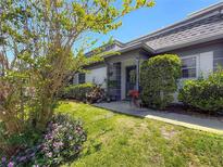 Charming home with lush landscaping, mature trees, and a well-manicured lawn at 1241 N Mcmullen Booth Rd, Clearwater, FL 33759
