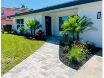 Charming home featuring a beautifully landscaped front yard and a welcoming walkway at 2528 Columbus S Way, St Petersburg, FL 33712
