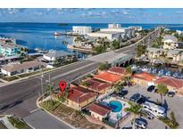 Stunning aerial view of waterfront property with a private pool, dock and convenient road access at 2600 N Paula Dr # 2B, Dunedin, FL 34698