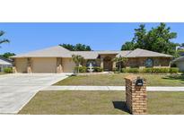Charming brick home featuring a well-manicured lawn, a fountain, and a two-car garage at 2914 Timber Knoll Dr, Valrico, FL 33596