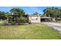 Charming single-story home with a covered porch and carport at 3407 Cason Rd, Plant City, FL 33566