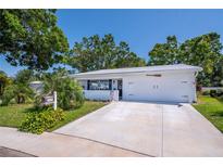Charming single-story home featuring a well-manicured front yard and a spacious two-car garage at 3408 90Th N Ter, Pinellas Park, FL 33782