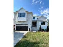 Stunning two-story home with a black garage door, brick accents, and landscaped front yard at 4607 W Lamb Ave, Tampa, FL 33629