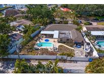 Aerial view of a fenced in yard with an in-ground pool, seating, and patio area at 843 37Th Ne Ave, St Petersburg, FL 33704