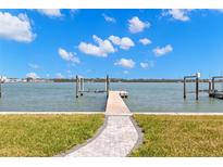 Waterfront backyard featuring a private dock with boat lift offering direct access to the bay at 844 Bay Point Dr, Madeira Beach, FL 33708