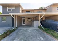 Charming townhome featuring an attached carport, updated exterior paint, and a private jacuzzi at 1700 Azalea Ct # B, Oldsmar, FL 34677