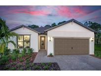 Charming one-story home featuring a two-car garage, a beautiful front yard, and a cozy entryway at 2535 Charter Oak Dr, North Port, FL 34289