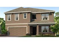 Charming two-story home featuring an attached two car garage and professionally landscaped yard at 35727 Lockman Way, Zephyrhills, FL 33541