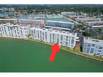 An aerial view of a waterfront apartment complex and neighboring residential buildings at 5980 Shore S Blvd # 403, Gulfport, FL 33707
