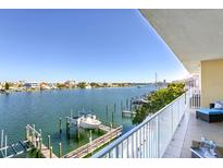 Waterfront condo view from balcony showcasing boat docks and serene blue waters with clear skies at 600 Bayway Blvd # 304, Clearwater, FL 33767