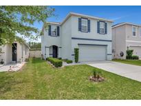 Charming two-story home with blue shutters and a well-maintained lawn at 6648 Seaway Dr, Brooksville, FL 34604
