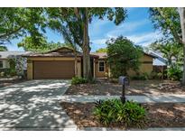 Charming single-Gathering home with a well-manicured lawn and a two-car garage in a quiet neighborhood at 740 Crystal Dr, Palm Harbor, FL 34683