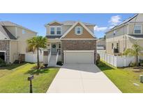 Charming two-story home with stone accents, manicured lawn, and a welcoming entrance at 7509 S Sherrill St, Tampa, FL 33616