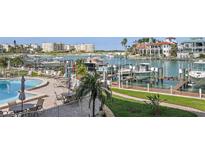Enjoy poolside relaxation at this waterfront property with boat docks and lush landscaping at 936 Pinellas Bayway S # T-5, Tierra Verde, FL 33715
