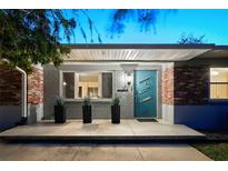 Charming home featuring a modern teal door and a well-maintained brick facade at 222 N Clearview Ave, Tampa, FL 33609