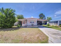 Charming single-story home with a covered carport, well-maintained lawn, and mature trees at 35128 Dale Ave, Zephyrhills, FL 33541