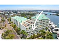 Condominium building featuring private balconies with views of the bay and docks at 399 C 2Nd St # 313, Indian Rocks Beach, FL 33785