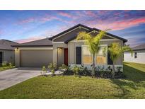Charming single-story home with a well-manicured lawn and lovely landscaping, creating great curb appeal at 4025 Capri Coast Dr, Plant City, FL 33565