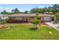 Charming home featuring a well-manicured lawn, brick accents, and lush landscaping at 4340 50Th S Ter, St Petersburg, FL 33711