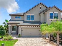 Charming two-story home featuring a neutral color palette, attached garage, and well-manicured landscaping at 4744 Wandering Way, Wesley Chapel, FL 33544