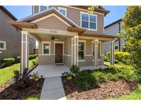 Charming two-story home with a covered front porch and meticulously landscaped yard at 5733 Colony Glen Rd, Lithia, FL 33547