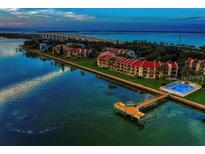 Beautiful aerial view of waterfront property with a dock and community pool at 7540 Sunshine Skyway S Ln # 217, St Petersburg, FL 33711