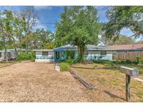 Charming single-story home with beautiful mature trees and low maintenance gravel landscaping at 10119 Cliff Cir, Tampa, FL 33612