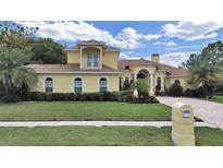 Charming two-story home with a well-maintained lawn and beautiful landscaping at 1312 Fishing Lake Dr, Odessa, FL 33556