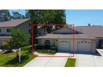 Charming single-story home with a well-manicured lawn and two-car garage at 2547 Stony Brook Ln, Clearwater, FL 33761