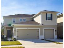 Charming two-story home featuring a two-car garage and neutral colored siding at 3000 Jacob Crossing Ln, Holiday, FL 34691