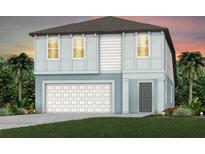 Charming two-story home with a two-car garage, lush green lawn, and tropical landscaping at 9967 Trellis Vine Way, Parrish, FL 34219